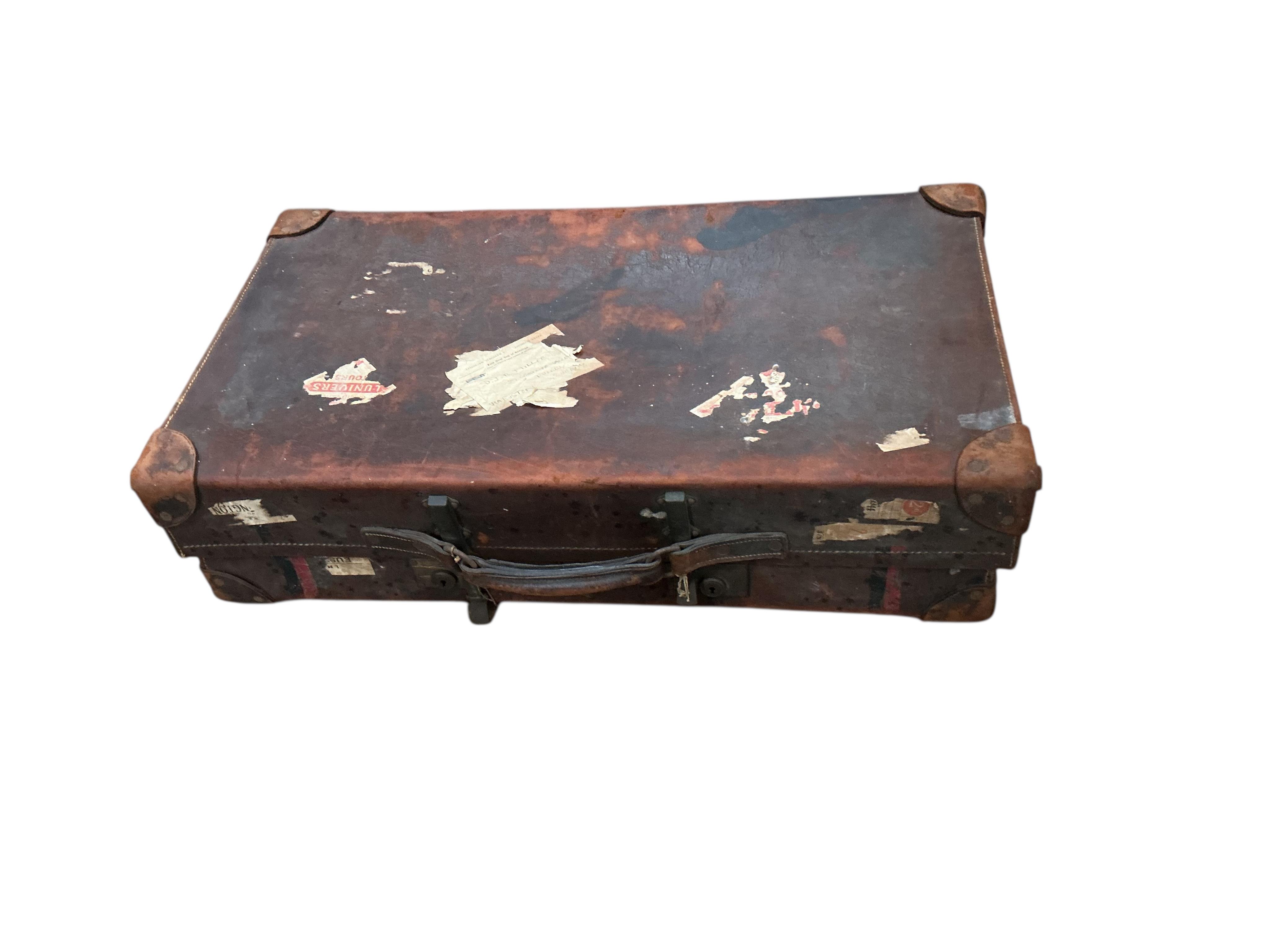 A WWI leather artillery shell case carrier, height 98cm, a wicker laundry hamper and a Revelation leather case